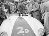 Phil Hill celebrates his success atop the 750 Monza following his win at the Del Monte Trophy Race at Pebble Beach in 1955.