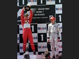 1998 Ferrari F300 - $Michael Schumacher celebrates his victory at the 1998 French Grand Prix next to a sombre Mika Häkkinen.