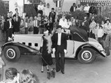 Mr. and Mrs. Prost stand with the Delage after winning the Mougins concours d'elegance in the 1970s.