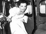 Joan Crawford climbing into her Cadillac in 1933.
