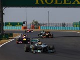 Hamilton leads in the W04 at the Hungarian Grand Prix, with Sebastian Vettel's Red Bull and Romain Grosjean's Lotus hot on his heels. Having clinched pole position in qualifying, Hamilton's victory marked the onset of the Silver Arrows' dominance in Formula 1.