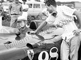 Phil Hill behind the wheel of 0598 CM chatting with Carroll Shelby at Hawaii Speed Week, held on Dillingham Air Base in Northern Oahu, April 1957.