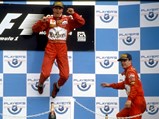 1998 Ferrari F300 - $Michael Schumacher jumps with joy after winning the 1998 Canadian Grand Prix, with his teammate Eddie Irvine is pictured