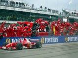 Ferrari pit crew celebrate Michael Schumacher securing 1st place at the 2003 USA Grand Prix.
